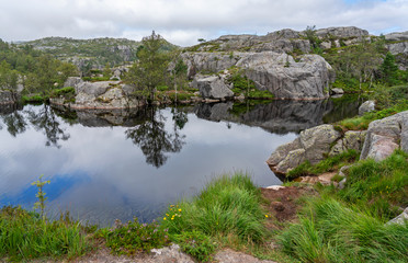 Fototapeta na wymiar Mountain lake landscape view, Norway. Tourist way to Preikestolen rock.