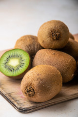 whole kiwi on a wooden stand