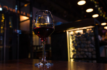 Glass of red wine on backlighted background