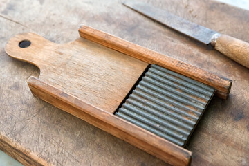 Old traditional wooden grater on wooden background