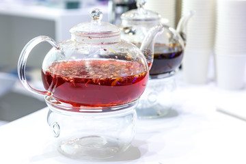 Two clear glass teapots with brewed tea