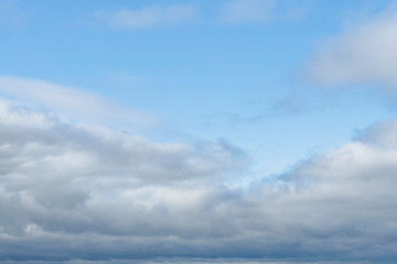 Amazing dark grey and white clouds during the sunset contrasted against a lighter color sky.