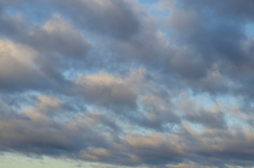 Amazing dark grey and white clouds during the sunset contrasted against a lighter color sky.