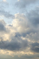 Obraz premium Amazing dark grey and white clouds during the sunset contrasted against a lighter color sky.