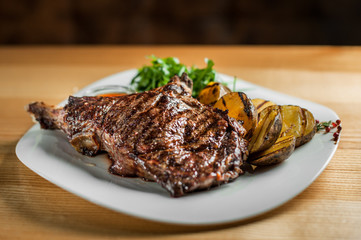 Juicy steak with vegetables , cooked on the grill.