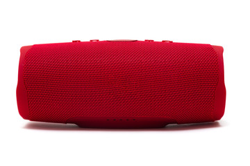 Portable bluetooth red speaker isolated on white background.