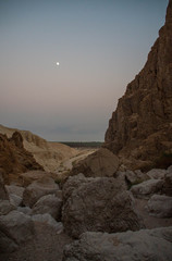 Moon rising above mountains of Judaean Desert in Dead Sea area at sunset, Israel