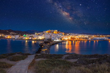 Chora of Naxos island as seen from the famous landmark the Portara with the natural stone walkway towards the village, Cyclades, Greece. - obrazy, fototapety, plakaty