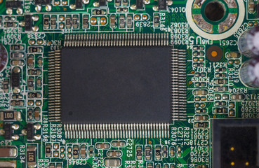  computer microchip on a circuit board with electrical parts