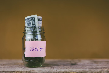 Savings jars full of money for mission, christian concept.