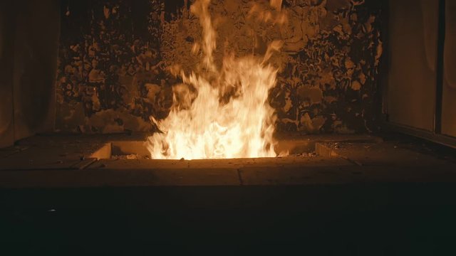 Forge fire in furnace. Blacksmith tempers a steel product in a stove. Smithy forging for hardening and heating iron. Blacksmith makes iron for manufacture of fireplace, stove. Burner Slow Motion.