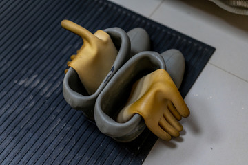 Rubber boots, galoshes and a rug