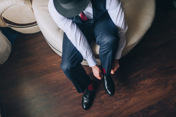 Lacing close up. A man businessman in a suit shoes black shoes and hands tied shoelaces. Business....