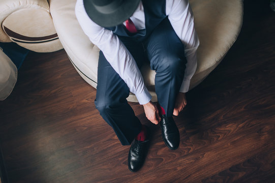 Lacing close up. A man businessman in a suit shoes black shoes and hands tied shoelaces. Business. Groom morning, wedding. Photography, concept.