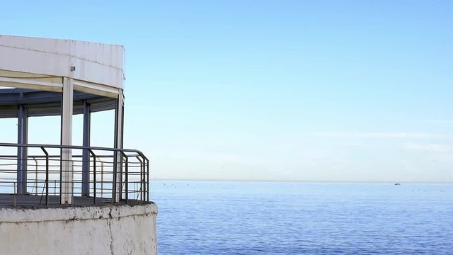 Scenic view of pier against seashore in Torrevieja, Alicante, Spain. El Tintero quisco over mediterranean Sea.
