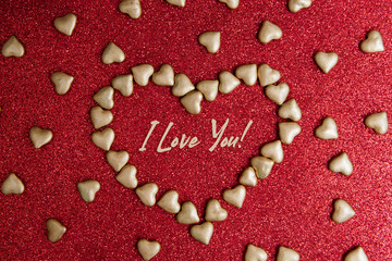 Heart shape made of small hearts on a red glitter background. A form for congratulations on Valentine's Day or wedding. Heart for lovers