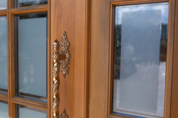 Vintage copper handle of a wooden door