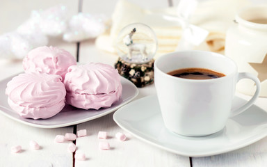 Pink marshmallow with a Cup of black coffee