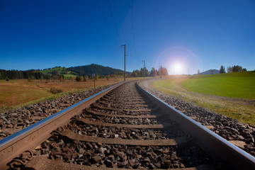 Fototapeta na wymiar Railroad track in Switzerland converging in horizon