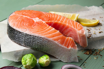 Raw salmon steak on table