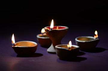 Obraz na płótnie Canvas Clay diya lamps lit during diwali celebration. Greetings Card Design Indian Hindu Light Festival called Diwali