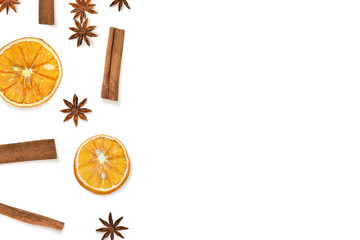 Border made of dried oranges, cinnamon and anise on white. Winter holidays composition with spices.