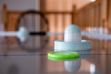 Close up of air hockey puck and table