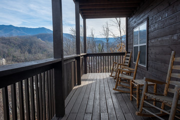 rocking chairs on porch looking over mountains