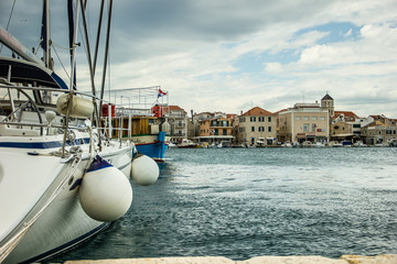 Vodice, Croatia / 17th May 2019: Seafront view on stormy day vith white boat in front