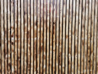 Wooden thin slats with traces of firing. Thin vertical slats.Wooden background.