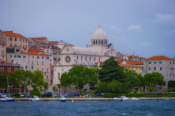 Fototapeta na wymiar Sibenik, Croatia / 18th May 2019 : Seafront view of Sibenik cathedral st James