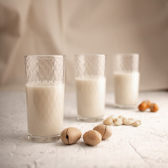 Three glasses with different types of organic milk. Nut milk without lactose, gmo, antibiotics and casein. Diet drink.