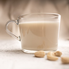 Glass cup with organic milk. Nut milk without lactose, gmo, antibiotics and casein. Diet drink. ..