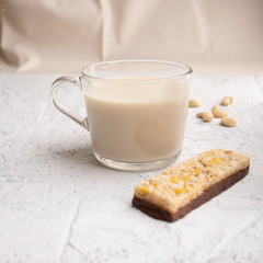 Healthy breakfast. Organic milk. Cereal granola bar. Glass cup with organic milk. Nut milk without lactose, gmo, antibiotics and casein. Diet food.  ..