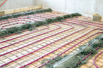 Installation of Underfloor heating, heated with antifreeze. Underfloor heating with heat transfer fluid. Cement screed with metal reinforcement