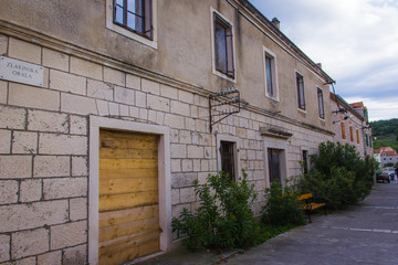 Fototapeta na wymiar Zlarin, Croatia / 18th May 2019: Old stone streets and houses in Zlarin island near Sibenik