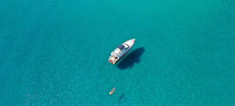 Aerial drone ultra wide photo of luxury yacht docked in tropical exotic turquoise beach