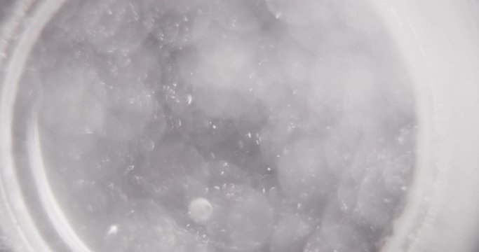 patient throws aspirin into a glass of water on a black background