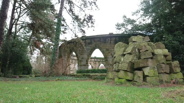 Historic stone monument and trees in green park