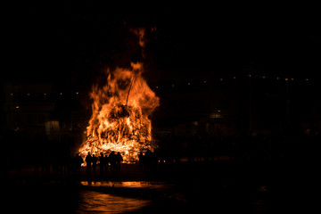 Silhouette of people watching a big bonfire