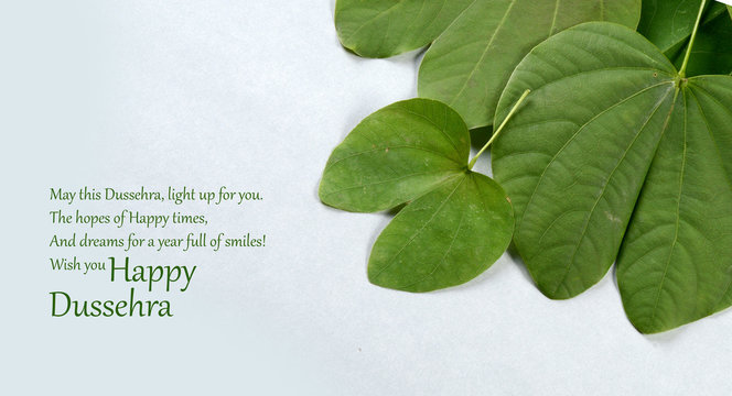 Indian Festival Dussehra, showing golden leaf on grey background. Greeting card.