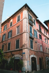 Fototapeta na wymiar Old street in Trastevere in Rome, Italy. Trastevere is rione of Rome, on the west bank of the Tiber in Rome, Lazio, Italy. Architecture and landmark of Rome