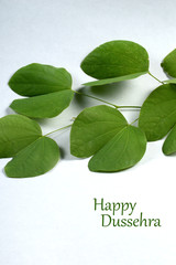 Indian Festival Dussehra, showing golden leaf on grey background. Greeting card.