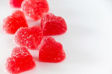 Red heart-shaped marmalade on a white background.