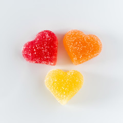 Three multi-colored  marmalade on a white background.
