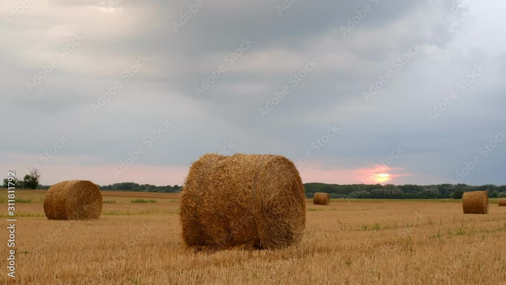 Poster hay bales in the sunset