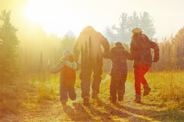 family running on country road in autumn time