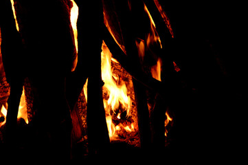 Close up of burning logs in the fireplace on black background