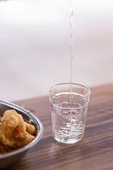 bottle and glass of beer on wooden table