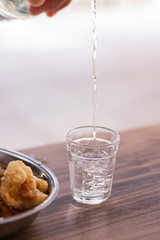 bottle and glass of beer on wooden table